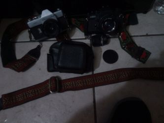 K. S. X. 50 MM CAMERA BY SEARS KSX AND MAMIYA/SEKOR 50/M.M. WITH ONE CASE,ONE FILM POUCH AND 3 CARRY STRAPS $15 FOR EVERYTHING.