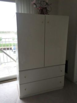 White lacquer armoire with golden hardware