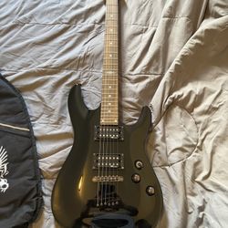 Electric Guitar With Case, Strap, And Fender Mustang