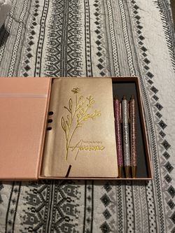 Notebook and glitter pens