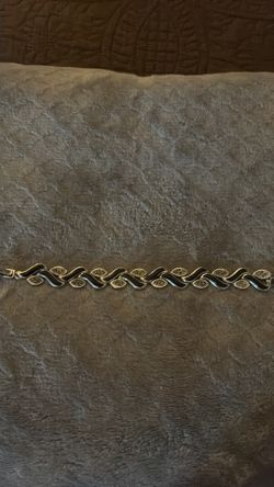 sterling silver bracelet features a stylized leaf design accented with black onyx and marcasite gemstones.