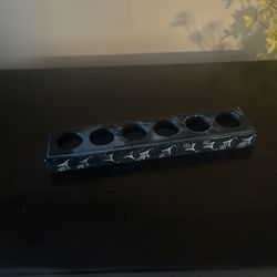black incense and six tea light holder.  It is designed to hold six standard tea light candles and incense sticks. The holder is black with a decorati