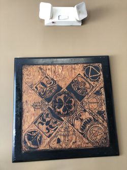 Hand painted one of a kind designed on a would table top. It’s in excellent condition with its hanging wire