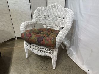 White Wicker Chair with Arched Backrest and Floral Cushion