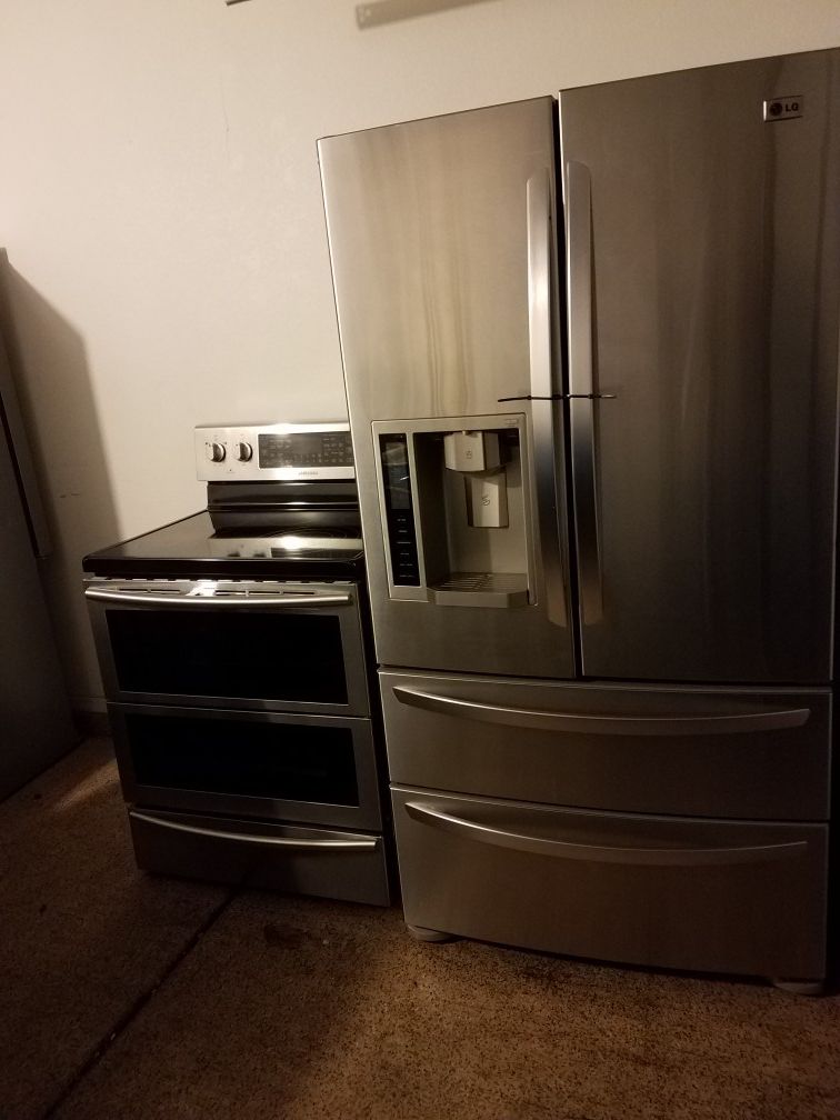 High end stainless steel french 4 door refrigerador and double oven electric stove