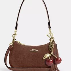 Coach Suede Leather Bag  Elegant suede leather bag by Coach. Chic, refined, and perfect for formal occasions or a polished look.