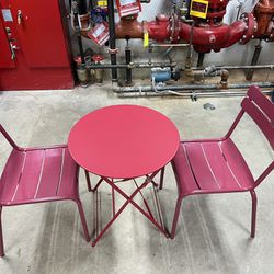 beautiful . table. of metal. with two. chairs.