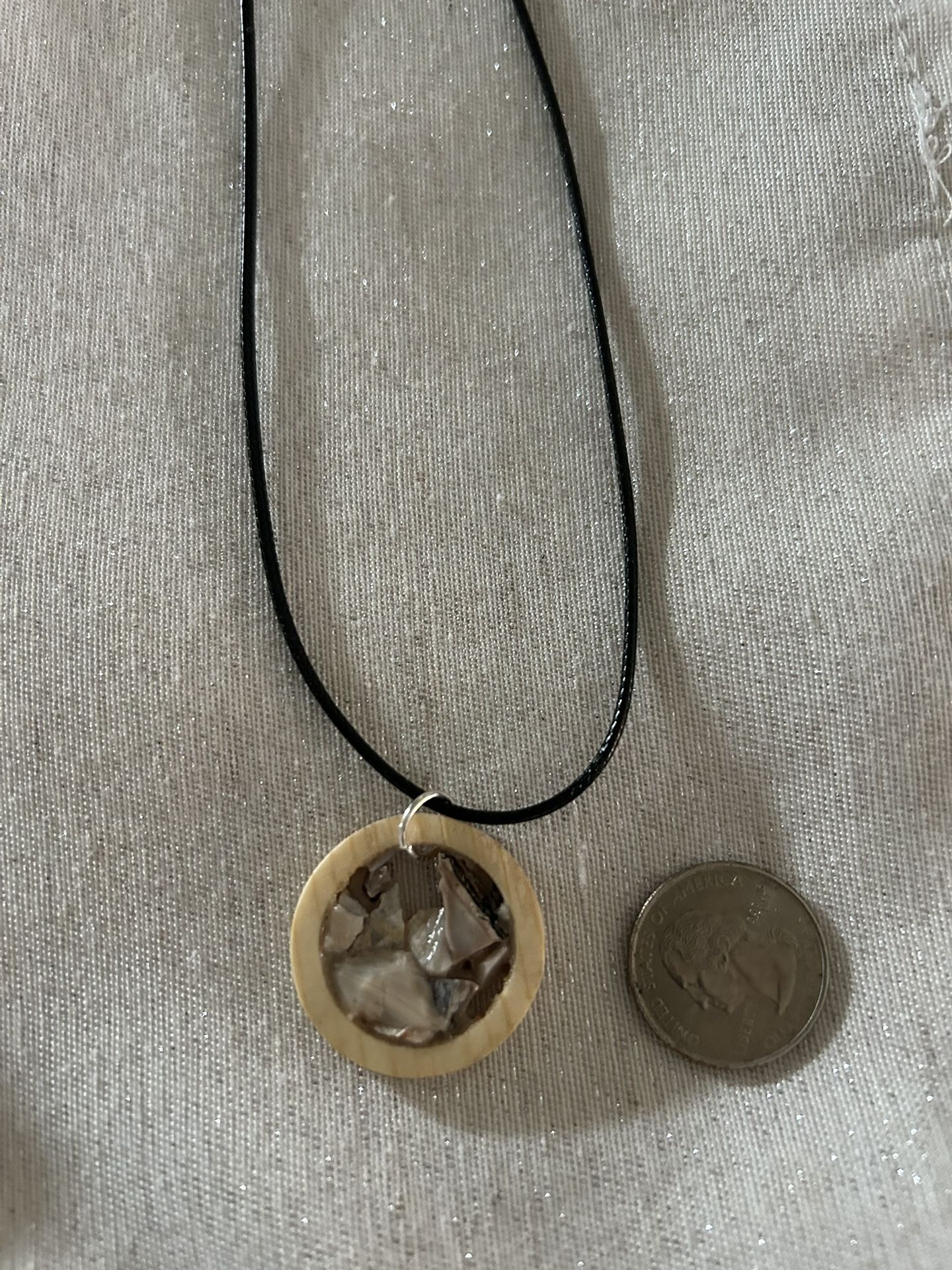 Necklace, Wood , Stone, And Shell Are The Materials