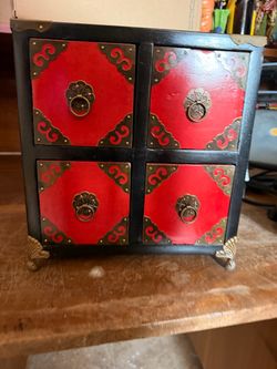small Asian-style red and black lacquer four-drawer chest