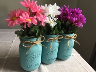 Distressed mason jar vases with silk flowers