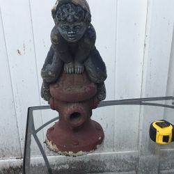 Concrete Statue Of A Boy Jumping Over A Fire Hydrant