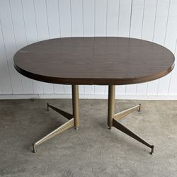 Sturdy oval dining table with metal frame