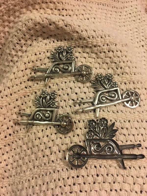Metal wheelbarrow with flowers , arts and craft , pins , put on the fridge with a magnet . $2.50each . Great for Mother’s Day
