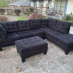 black micro suede reversable sectional, and ottoman