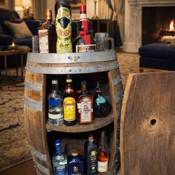 Handcrafted bar cabinet made from a wooden barrel.