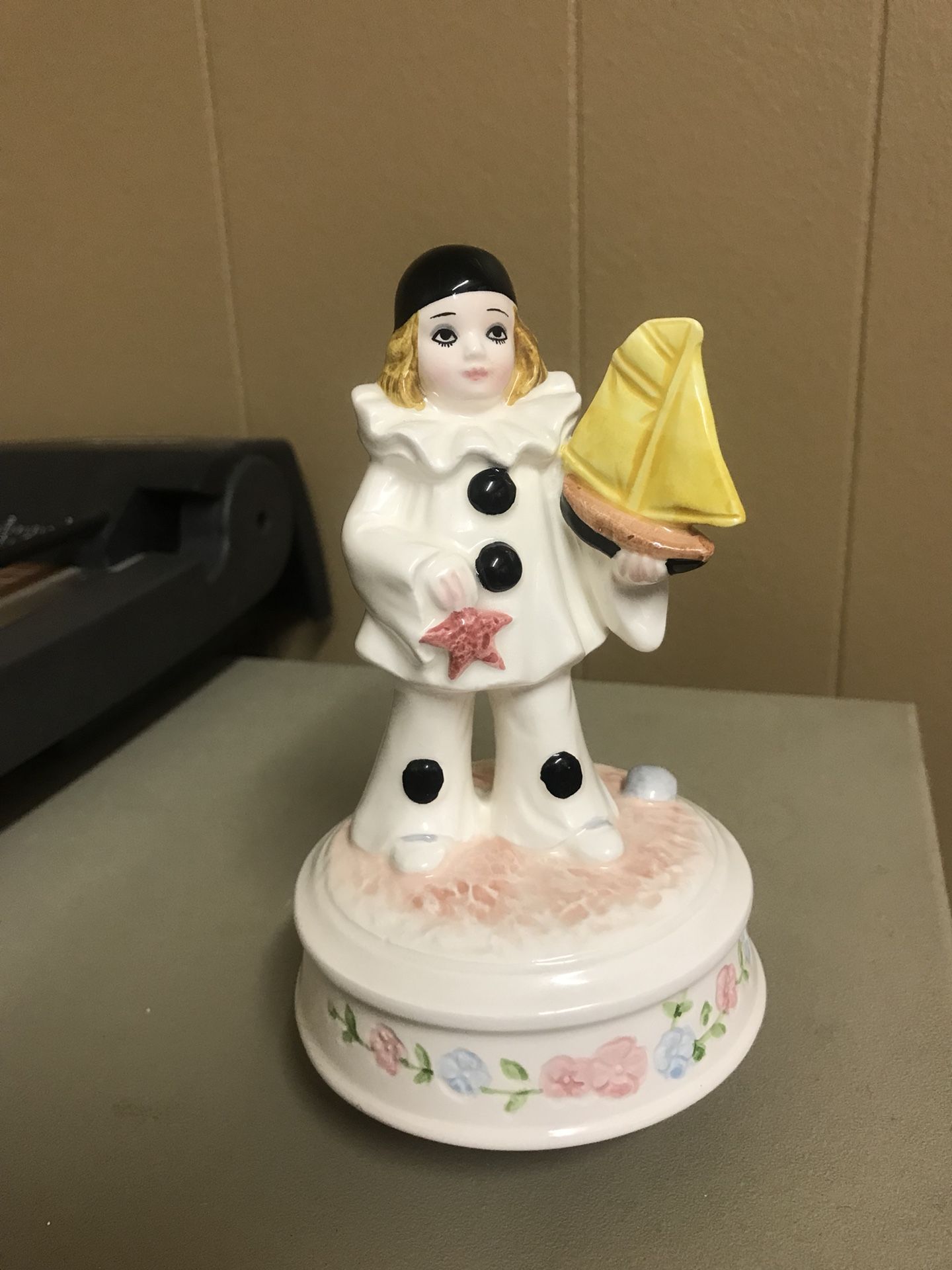 Schmid peirott love girl clown figurine holding yellow sailboat. Plays my favorite things from the sound of music. It turns when plays. But is slow