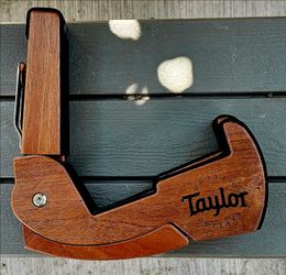 Taylor Travel Guitar Stand is a collapsible sapele wood stand featuring neoprene padding for instrument protection