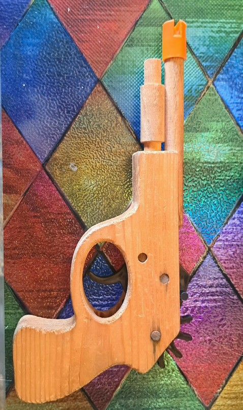 Vintage wooden rubber band shooter toy. 