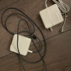 Two MacBook chargers with white and green wire
