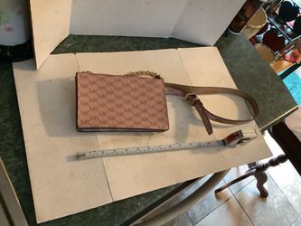 Michael Kors Pull Chain Belt Bag Signature Fanny Pack   This faux leather belt bag's brand logo print and pull chain transform it into a subtle statem