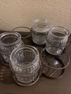 Votive candle holder opens up to place around outside umbrella