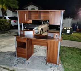 Free: Wooden desk with hutch and metal frame, featuring multiple storage compartments and drawers for organization. It's available!