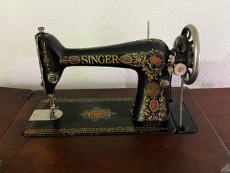 Singer red eye treadle machine with wood cabinet, cast iron base