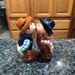 Cowboy and Cowgirl Kissing Magnetic Ceramic Salt and Pepper Shakers.  Size appropriately 4 inches tall.  Brand new with tags no box by Pacific Giftwar