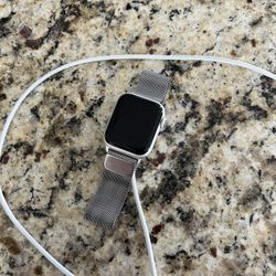 Apple Watch Includes silver magnetic band and charger.