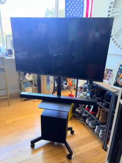 Tv, sound bar with sub woofer and rolling tv rack
