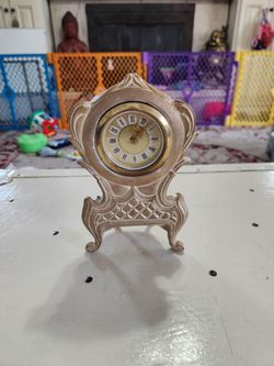 Wind up antique German mini clock/ doesnt work but it sounded like something is loose inside