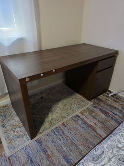 Computer desk.Ikea brand.Brown color.Height 28 1/2.Width 55.Depth 25 1/2