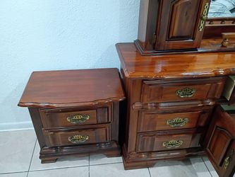 Solid wood dresser with mirror and two matching nightstands.