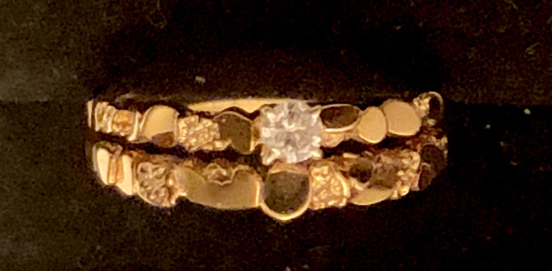 Woman’s 14 karat yellow gold nugget style diamond wedding set