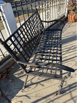 2 black metal benches with tables