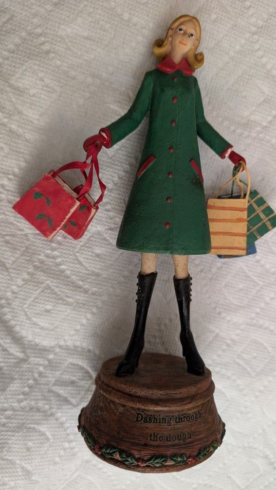 NEW Cute Girl Statue With Lots Of Shopping Bags. On The Bottom it says "Dashing Through The Dough". Great Christmas Gift Idea For Wife Or Teenager. St
