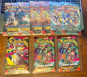 Pokemon - Lot of (9) Booster Packs: Chaos Rising + Mega Evo + Journey + Surging Sparks