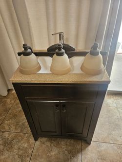 Bathroom vanity sink. Faucet, light fixture