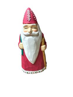 Colonial of Cape Cod Old St. Nicholas taper candle holder. It is a collectible item crafted from ceramic or porcelain.  The figurine is designed in a 