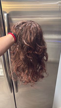 Wavy layered hair wig with bangs.