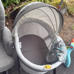 Grey Rocking Chair And Folding Bassinet 