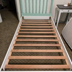 Two Jenny Lind twin bed frames with mattresses