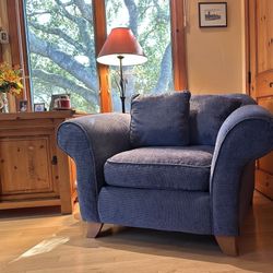 Blue roll arm chair with extra pillow and matching ottoman