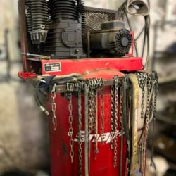 Snap-on 80-gallon vertical air compressor with chains hanging on it