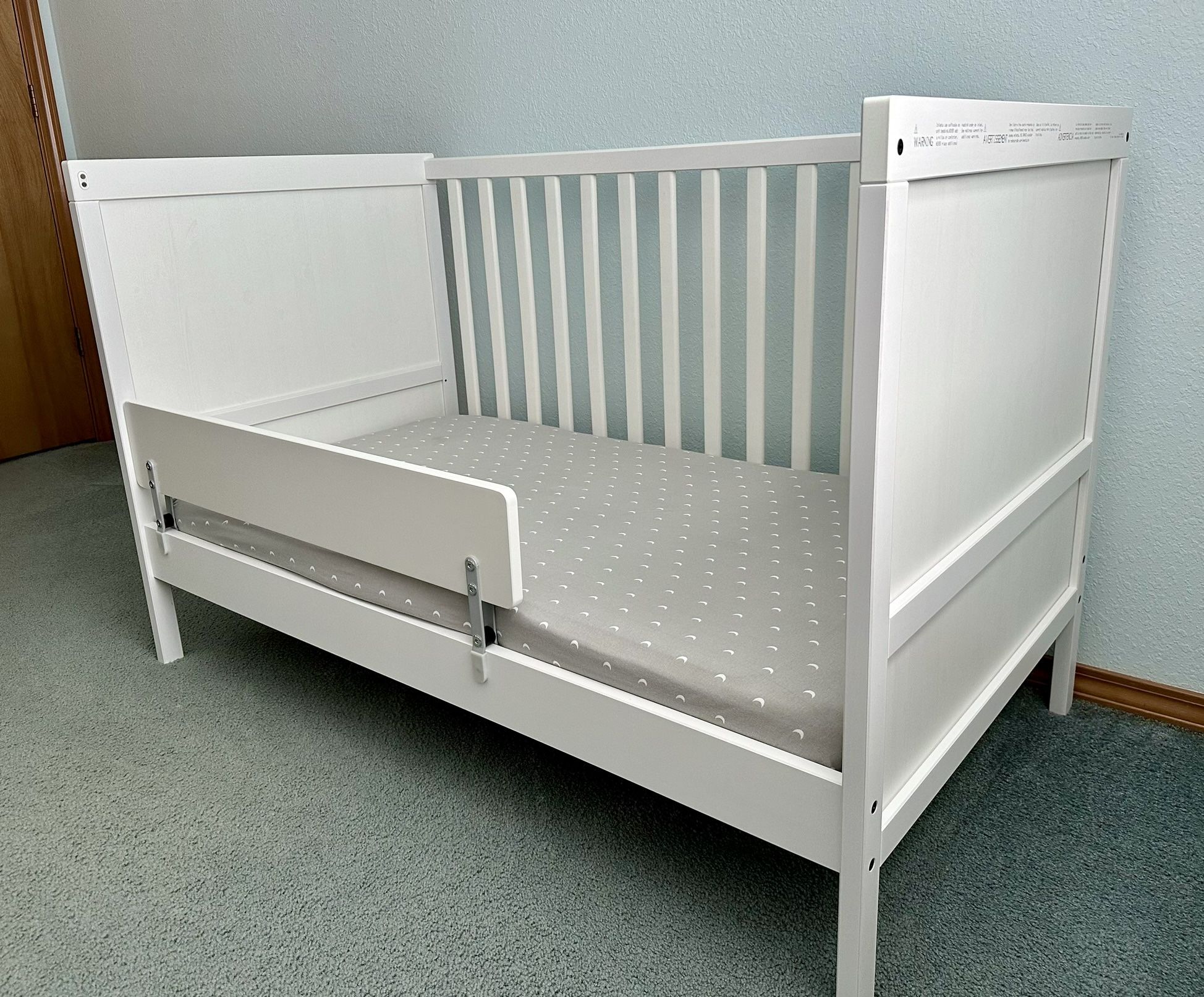 Like-new IKEA Crib with Toddler Bed Rail + Mattress & Bedding