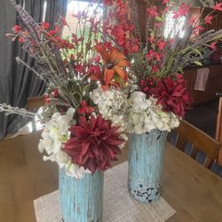 Two glass mosaic blue vases with faux flowers included. 