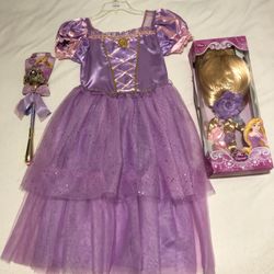 Rapunzel Halloween costume with wig and wand.