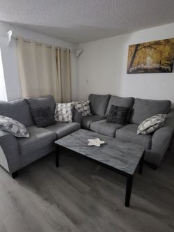 Gray sofa and love sest with coffe table