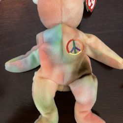 Ty beanie baby called peace with tags. Attached has been stored in a clear acrylic box not played with.