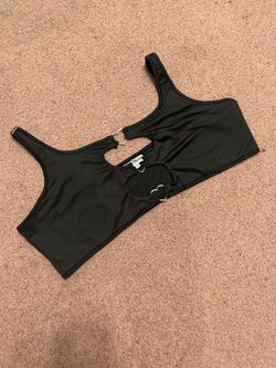 Fitted black crop tank with double heart cutouts at the front. Soft, stretchy fabric for a snug fit. Scoop neckline and supportive straps. Cute statem